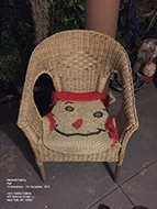 Wicker chair, with face shaped rug overtop