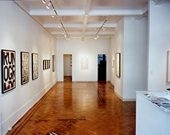 Installation view of framed text based paintings