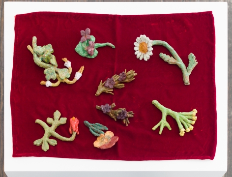 Closeup of small clay sculptures, shaped like flora