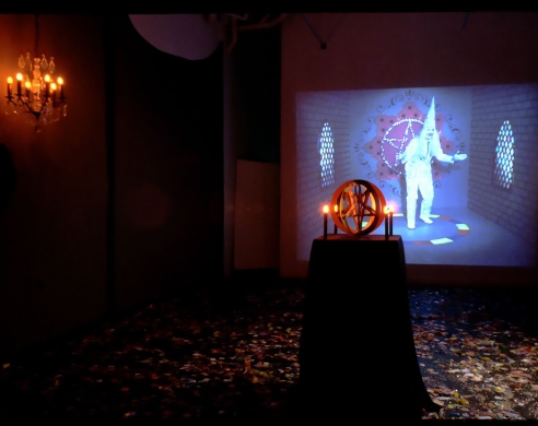 Installation view of darkened gallery, with projection playing
